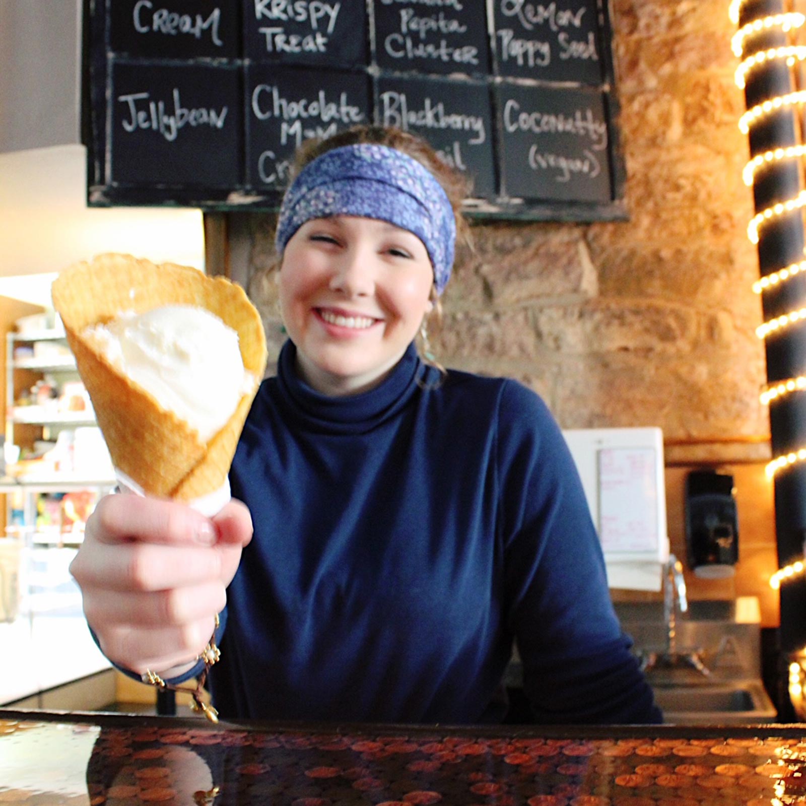 Teammate offering ice cream in waffle cone